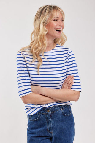 Woman wearing blue and white Breton striped 3/4 sleeve shirt and blue jeans