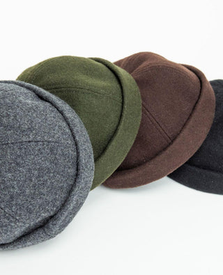 Wool beanie caps in grey, green, brown, and black on a white background