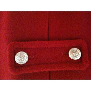 Close-up of red wool coat with silver decorative buttons
