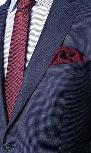 Navy wool suit jacket with red tie and matching pocket square, classic menswear style