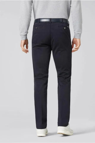 Men's navy cotton pants, back view, with belt and white sneakers